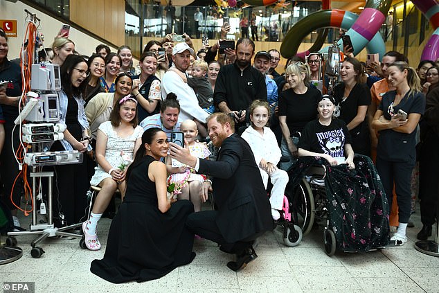 Harry and Meghan pose for a selfie with patients at the Royal Children's Hospital in Melbourne on the first day of their Australian visit