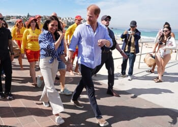 Prince Harry, and Meghan, the Duke and Duchess of Sussex, walk along the boardwalk after meeting volunteer first responders from Bondi Surf Bathers' Life Saving Club, during a visit to Bondi Beach on Friday
