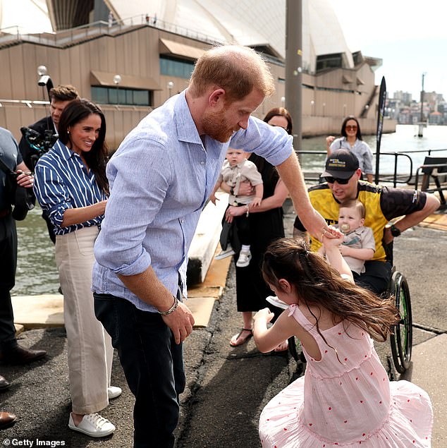 Prince Harry, Duke of Sussex dances with Charlotte Vanderzwan at an Invictus Australia event by the Sydney Opera House