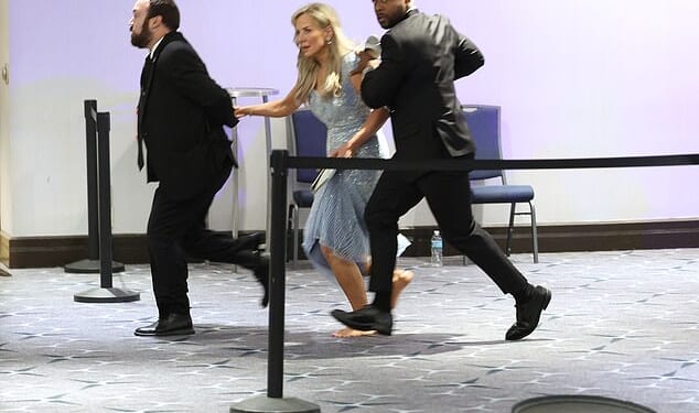 Guests are assisted and whisked away during the White House Correspondents' Dinner shooting aftermath