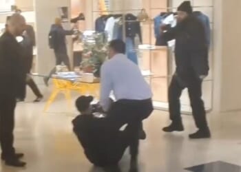 An activist is dragged across the floor during the protest in Louis Vuitton, Bond Street, on Friday