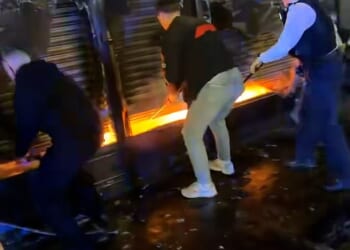 A heroic group of passers-by bravely levied up shutters of a food shop in a bid to save a man trapped inside