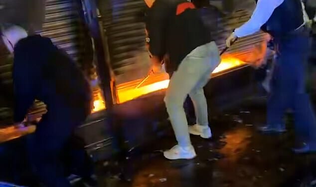 A heroic group of passers-by bravely levied up shutters of a food shop in a bid to save a man trapped inside