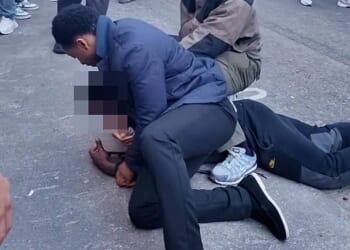 Moment teenage 'shoplifter' is pinned to the road in Mayfair by security guards seconds after 'stealing shoes from nearby shop'