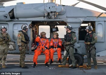 Victor Glover, left, and Christina Koch, right, after successfully splashing down following their historic moon mission