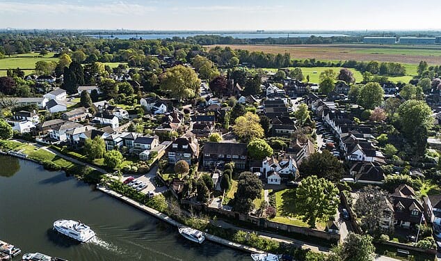 The Home Office has been placing migrants in the quintessentially English village of Laleham in Surrey (pictured)