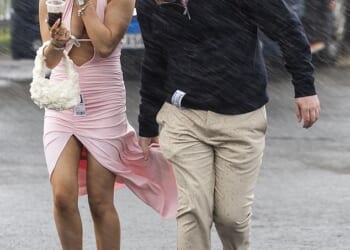 Glamorous racegoers at The Coral Scottish Grand National in Ayrshire, Scotland, were hit with rainy weather