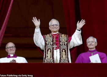 Pope Leo XIV appears on the balcony of St Peter¿s Basilica for the first time in a striking red mozzetta and gold-embroidered stole, a look Vogue later named his ¿best outfit of 2025¿