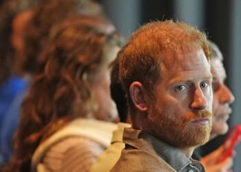 Prince Harry opens up about the 'real struggles' of fatherhood as he reveals he went to therapy as a new dad during emotional talk at AFL club - while Meghan is nowhere to be seen