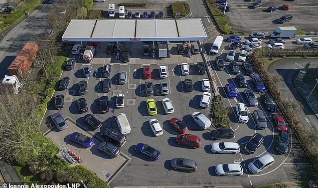 Long queues for fuel are seen at a Costco petrol station in Manchester today