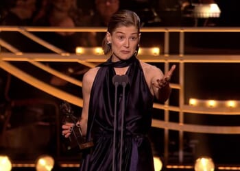 Gone Girl actress Rosamund Pike was seen breaking down in tears as she paid tribute to her partner for 'staying home and taking care of her sons' while she worked