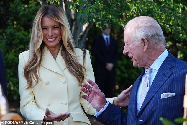 First Lady Melania Trump laughs with Britain's King Charles III as they tour the White House Beehive on the South Lawn