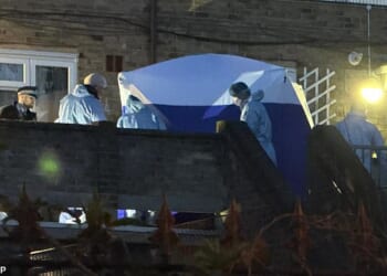 Police have launched a murder probe after a 14-year-old boy was shot dead in broad daylight in Woolwich London on Thursday (Pictured: The scene on Lord Warwick Street)