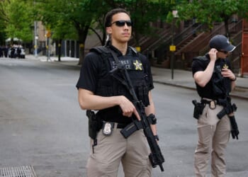 Armed Secret Service agents stand near non-profit Harlem Grown before a visit by Britain's King Charles III in New York Wednesday. Agents detained a man who bypassed a security barrier Tuesday near the White House while the king was in Washington, D.C.