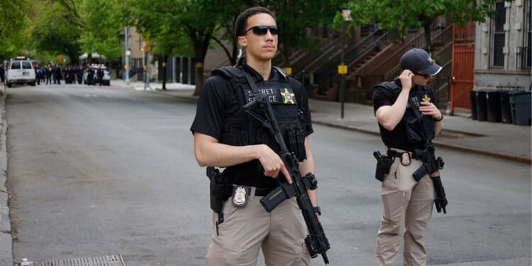 Armed Secret Service agents stand near non-profit Harlem Grown before a visit by Britain's King Charles III in New York Wednesday. Agents detained a man who bypassed a security barrier Tuesday near the White House while the king was in Washington, D.C.
