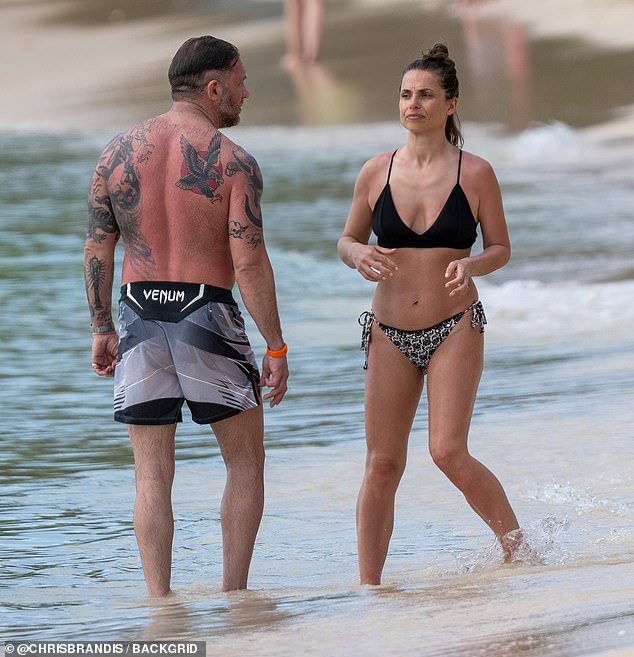 The actor, 48, who plays Venom in the titular DC franchise, was shirtless in a pair of branded UFC shorts as he took a dip in the sea with his actress partner, 44