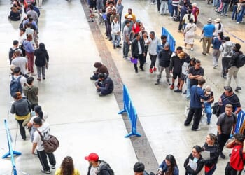 People queue to receive documentation in Hospitalet de Llobregat, near Barcelona, Spain
