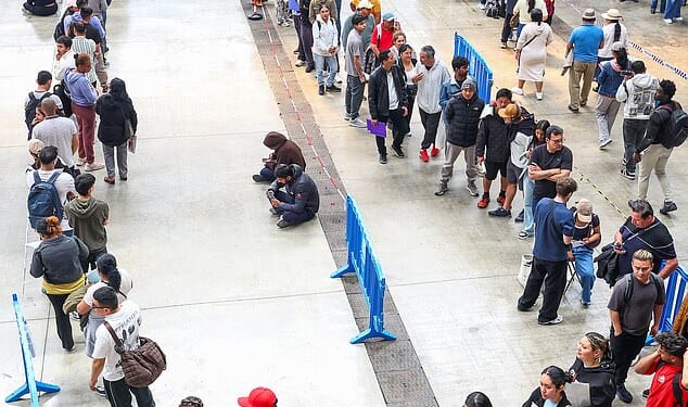 People queue to receive documentation in Hospitalet de Llobregat, near Barcelona, Spain