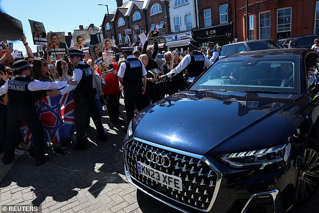 Starmer avoided the showdown with angry locals and was branded a 'coward' and a 'traitor'. Pictured: a convoy of cars carrying the PM driving past protesters in Golders Green today