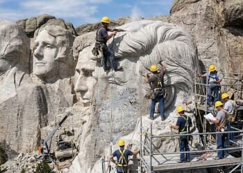 Workers carve Donald Trump's hairdo into Mount Rushmore in South Dakota