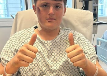 Mike Angland pictured in hospital after his heart stopped for 13 minutes when he fell on to Tube tracks in north London