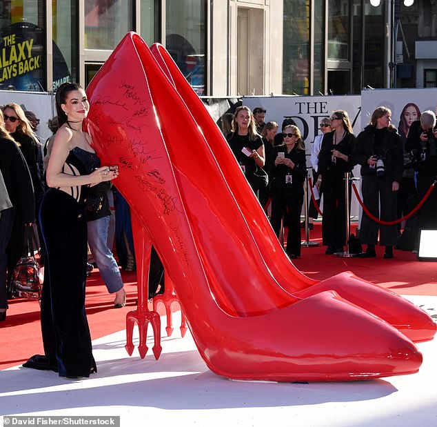 She posed beside a giant pair of red stilettos
