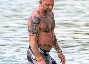 The Hollywood action stars embracing a dad bod in their downtime after Tom Hardy was seen hitting the beach in Barbados (pictured) - as it's revealed women prefer a relaxed physique