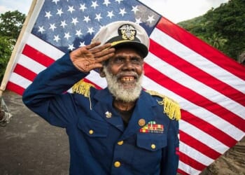 A leader of the John Frum movement salutes in front of an American flag on the remote island of Tanna in Vanuatu