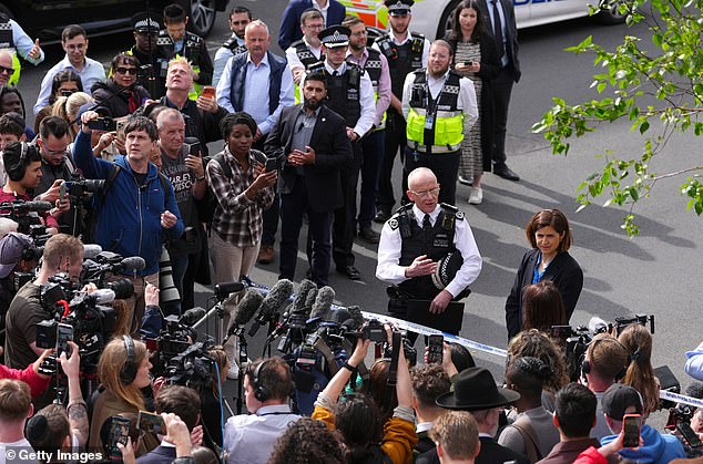 An aerial photo of the Met commissioner addressing reporters