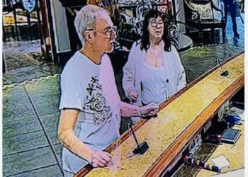 British tourist Lorna McSorley, 71, (right) pictured with her partner Leon Probert (left) at the reception desk of the Ghost Mountain Inn where the couple were staying