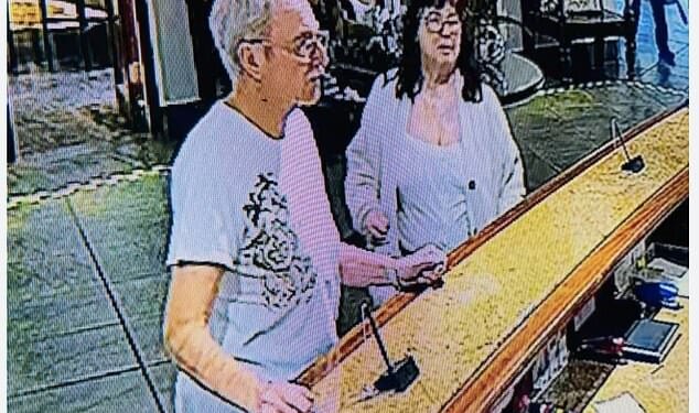 British tourist Lorna McSorley, 71, (right) pictured with her partner Leon Probert (left) at the reception desk of the Ghost Mountain Inn where the couple were staying