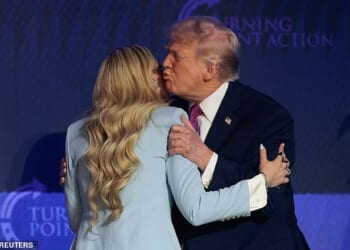 President Donald Trump (right) gives Erika Kirk (left) a hug and a kiss as he arrives Friday at Dream City Church in Phoenix, Arizona, for a Turning Point USA 'Build the Red Wall' event