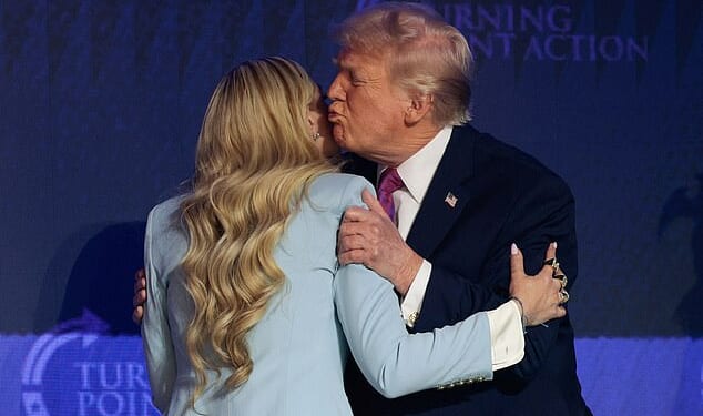 President Donald Trump (right) gives Erika Kirk (left) a hug and a kiss as he arrives Friday at Dream City Church in Phoenix, Arizona, for a Turning Point USA 'Build the Red Wall' event