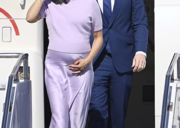 Second Lady Usha Vance cradled her growing baby bump as she and husband Vice President JD Vance arrived in Budapest on Tuesday - with her July due date just a few months away
