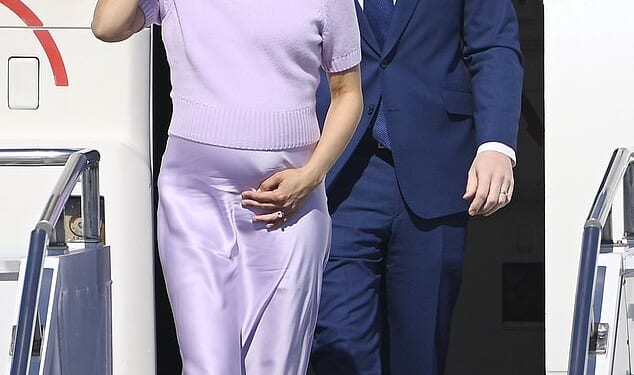 Second Lady Usha Vance cradled her growing baby bump as she and husband Vice President JD Vance arrived in Budapest on Tuesday - with her July due date just a few months away