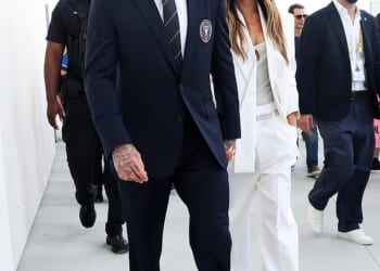 Victoria Beckham looked effortlessly chic in a white suit as she walks hand in hand with husband David to the ribbon-cutting ceremony for his team's new stadium