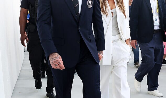 Victoria Beckham looked effortlessly chic in a white suit as she walks hand in hand with husband David to the ribbon-cutting ceremony for his team's new stadium
