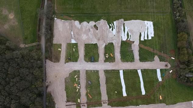 Villagers have been left furious after a group thought to be travellers barged their way onto a field near Friendless Lane in Hertfordshire and began laying down concrete (pictured)