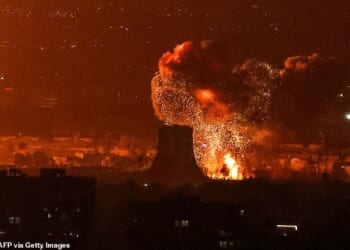 An explosion erupts following strikes near Azadi Tower close to Mehrabad International Airport in Tehran