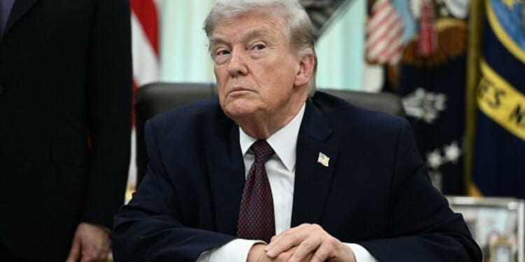 President Donald Trump sits at the Resolute Desk in the Oval Office on March 31, 2026.