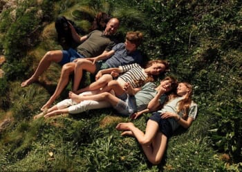 There’s William with a golden tan, showing off his muscular thighs; cheeky Louis is linking fingers with his mum, while Charlotte is laughing and showing off her trendy blue-painted fingernails. Only George looks uncomfortable and unsmiling