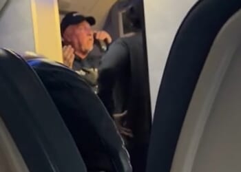 Footage from inside Delta Air Lines Flight DL2879 saw a male passenger losing his cool over a three to four hour delay amid the severe storms plaguing middle America on Monday