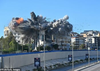 A ball of fire rises from the site of an Israeli strike that targeted a building adjacent to the highway that leads to Beirut's international airport on March 31