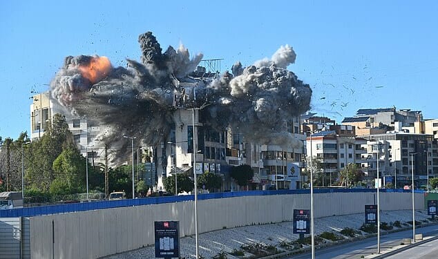 A ball of fire rises from the site of an Israeli strike that targeted a building adjacent to the highway that leads to Beirut's international airport on March 31
