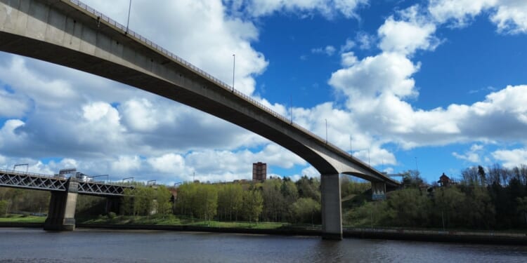 Woman, 48, arrested after man falls into river following ‘altercation’ on a busy bridge as cops search water