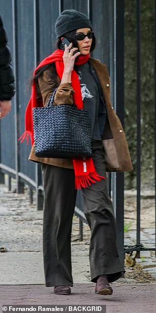 On her outing she cut a low key figure in a beanie hat and shades and wrapped a striking red scarf around her neck