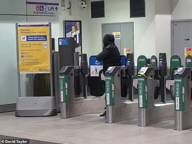 One of the men seen pushing through the wide gate at the Romford station barriers last night
