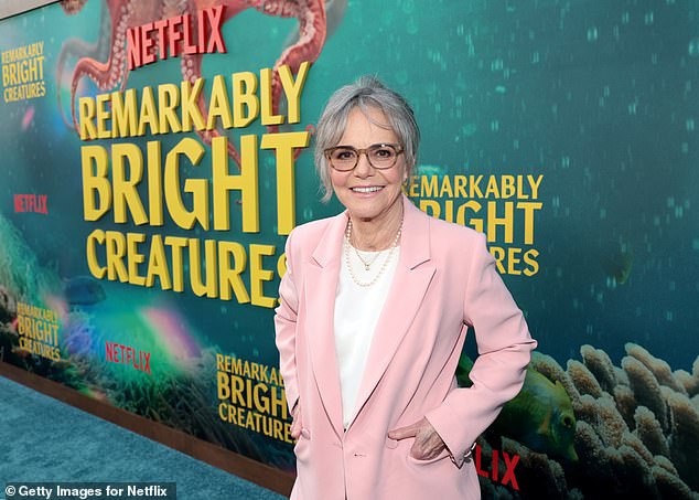 The actress opted for a chic matching pink suit, which she paired with a plain white t-shirt and a pair of white trainers, accessorising with strings of pearls