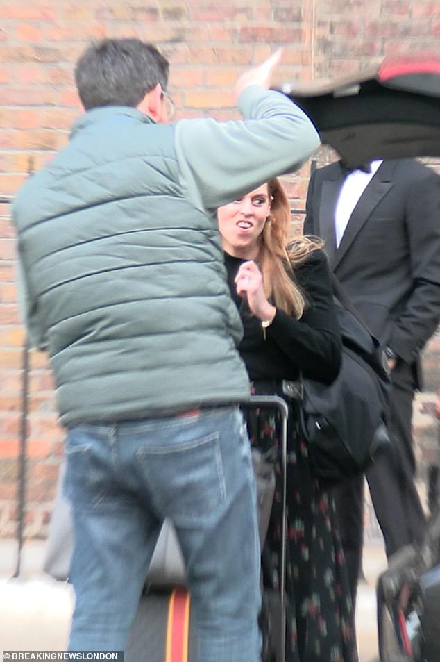 The 37-year-old, dressed in a floral dress and black blazer, took her place in the back of the car before leaving