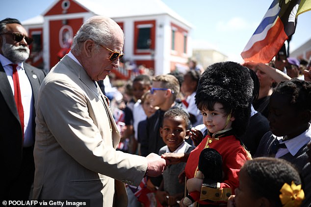 Charles meets Theo Godfrey, four, who is fittingly dressed in a replica King's Guard uniform